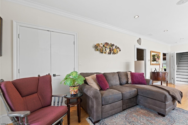 living room with stairway, light wood-style flooring, ornamental molding, and recessed lighting