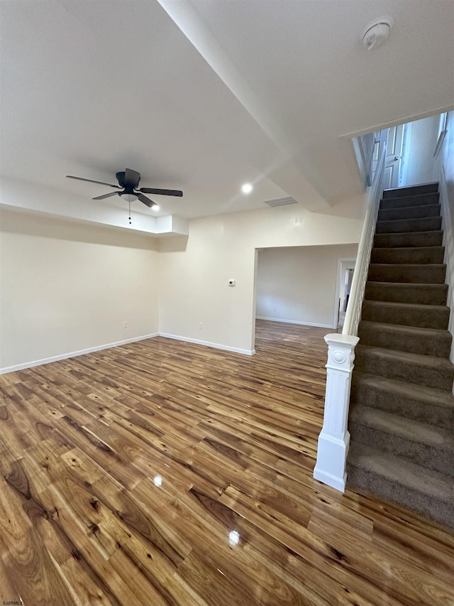 unfurnished living room with recessed lighting, baseboards, ceiling fan, stairs, and wood finished floors