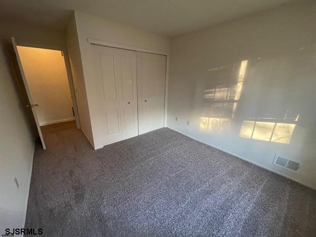 66 Sussex Ln Unit 66, Galloway Township, NJ 08205 - unfurnished bedroom with carpet flooring, a closet, and visible vents