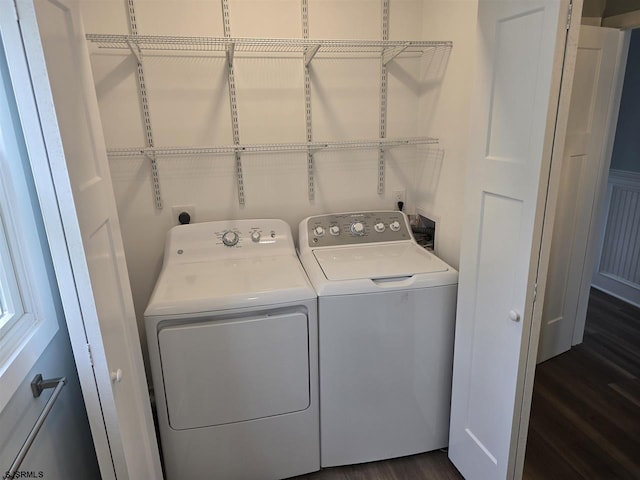 clothes washing area with separate washer and dryer, laundry area, and dark wood-style floors
