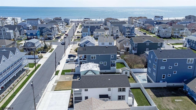 drone / aerial view with a water view and a residential view