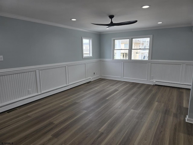 spare room featuring ornamental molding, a baseboard radiator, wainscoting, and ceiling fan