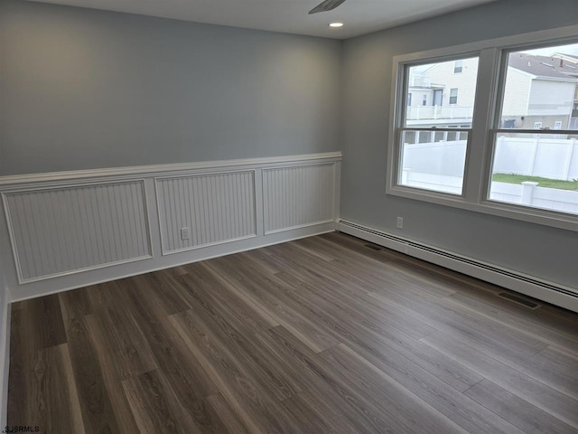 unfurnished room with recessed lighting, baseboard heating, and wood finished floors