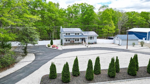 411 Spencer Ln, Galloway Township, NJ 08205 - view of front facade featuring an outdoor structure, fence, a porch, and driveway