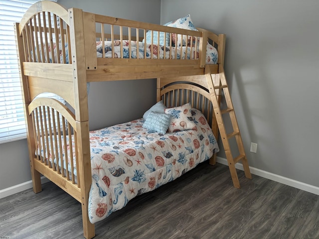 bedroom with wood finished floors and baseboards