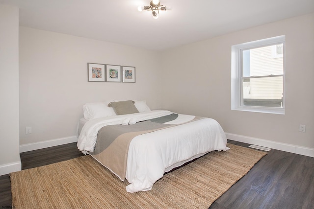 bedroom featuring wood finished floors and baseboards