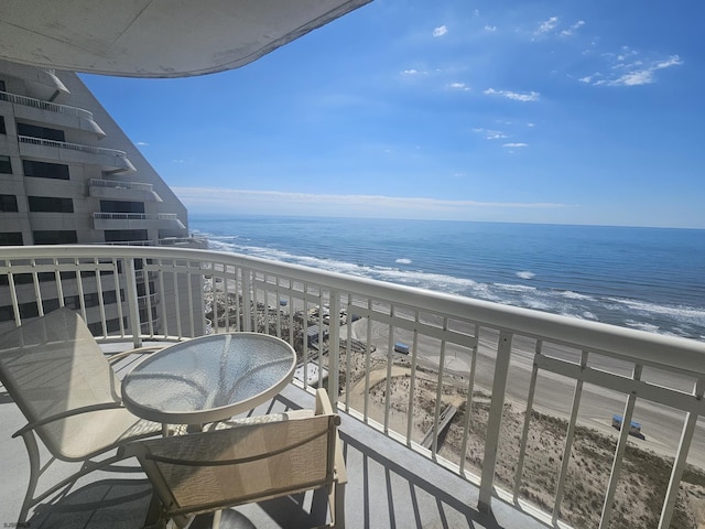 balcony with view of water and beach