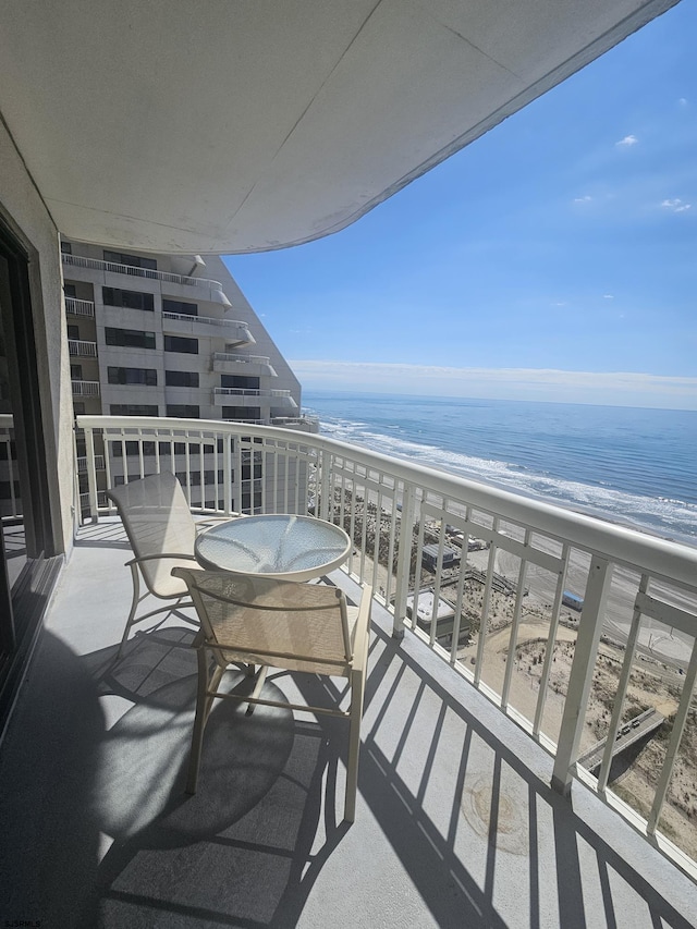 balcony with view of water and beach