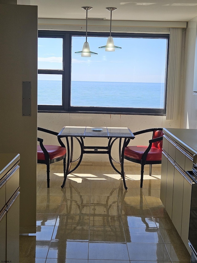 dining area featuring dark tile patterned floors