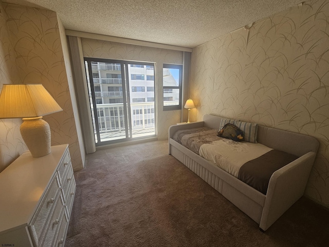 carpeted bedroom featuring wallpapered walls, access to outside, and a textured ceiling