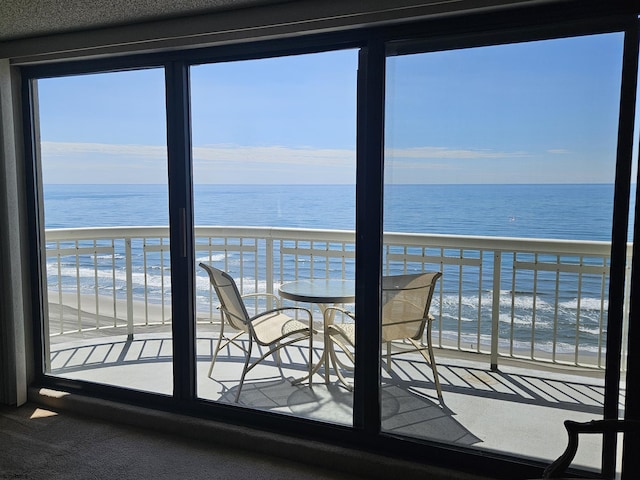 balcony with view of water and beach