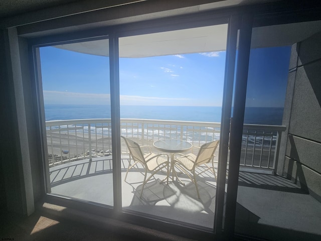 balcony featuring view of water and beach