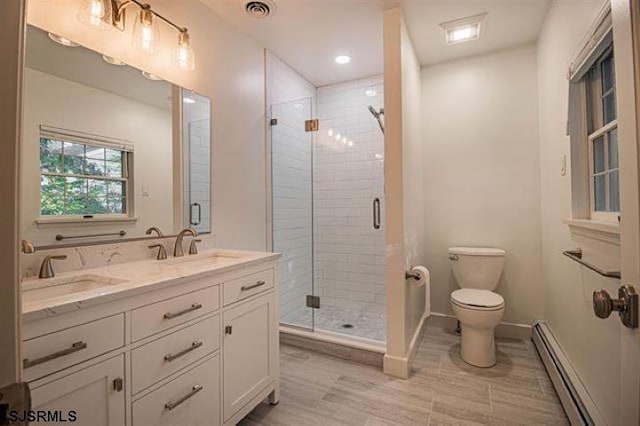 862 Central Ave, Hammonton, NJ 08037 - bathroom featuring baseboard heating, a shower stall, toilet, baseboards, and double vanity