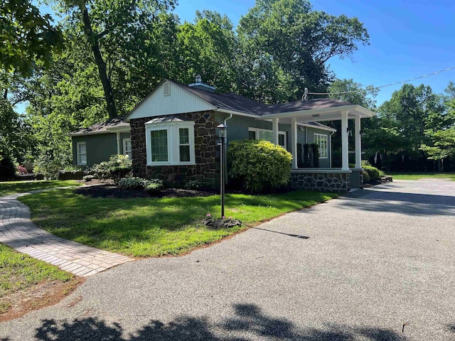862 Central Ave, Hammonton, NJ 08037 - view of front of home featuring stone siding, a front yard, asphalt driveway, and a porch
