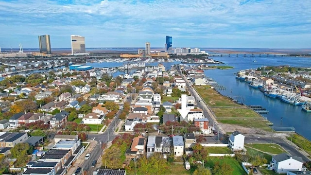 aerial view of property's location featuring a nearby body of water and nearby suburban area