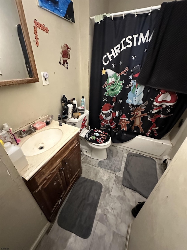 bathroom with vanity, a shower with shower curtain, and toilet
