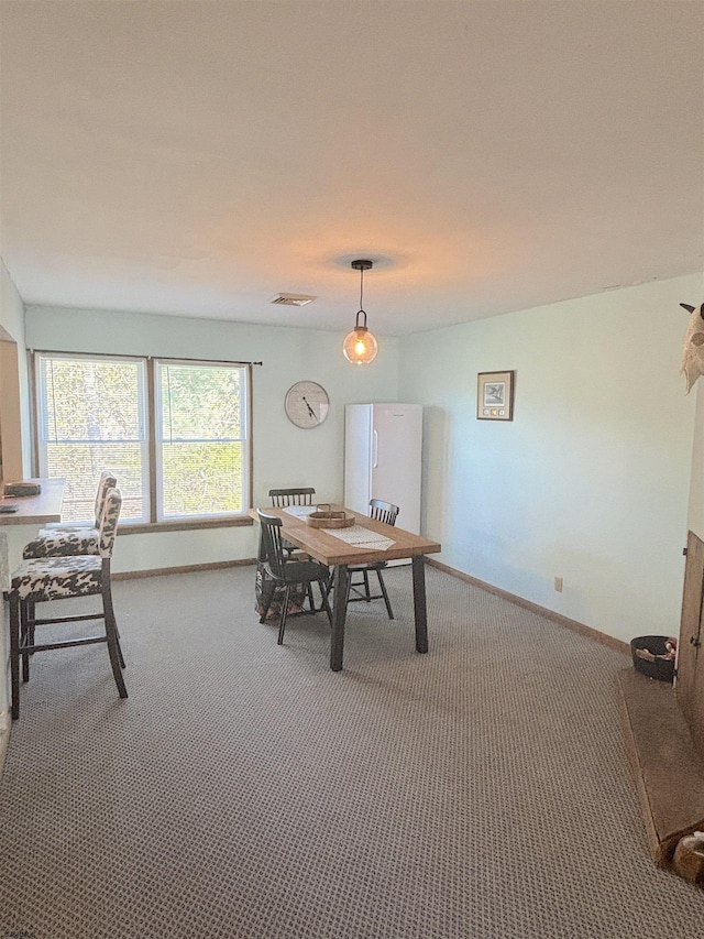 dining area featuring carpet floors and baseboards