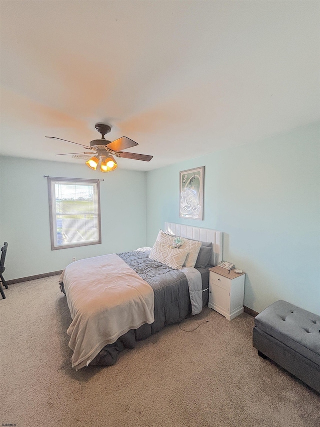 carpeted bedroom featuring ceiling fan and baseboards