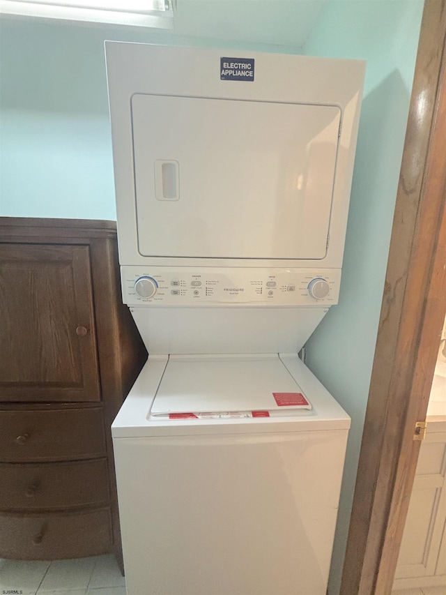 clothes washing area with stacked washer and clothes dryer