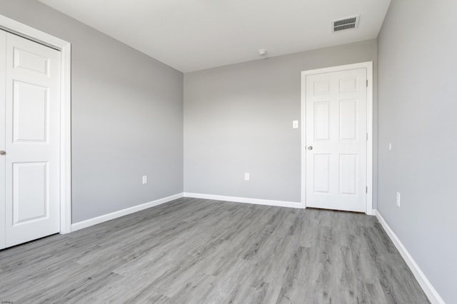 unfurnished room featuring light wood finished floors and baseboards