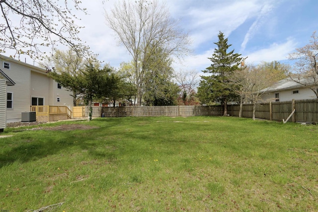 view of yard with central AC and a wooden deck