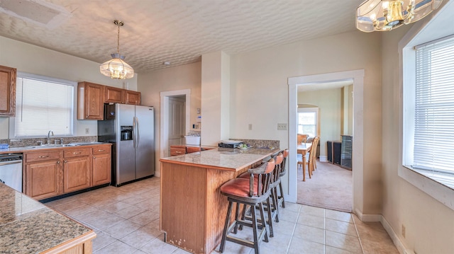 919 Broad St, Pleasantville, NJ 08232 - kitchen featuring appliances with stainless steel finishes, tile counters, a chandelier, and light tile patterned floors