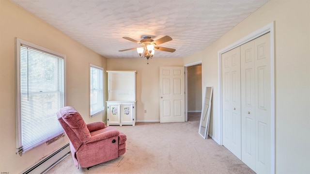 919 Broad St, Pleasantville, NJ 08232 - living area featuring a baseboard heating unit, a ceiling fan, light carpet, and baseboards