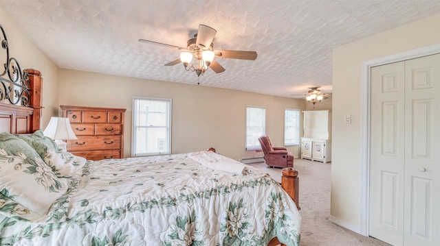 919 Broad St, Pleasantville, NJ 08232 - carpeted bedroom featuring multiple windows, a baseboard heating unit, and a ceiling fan