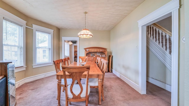 919 Broad St, Pleasantville, NJ 08232 - dining area featuring a chandelier, light colored carpet, and baseboards