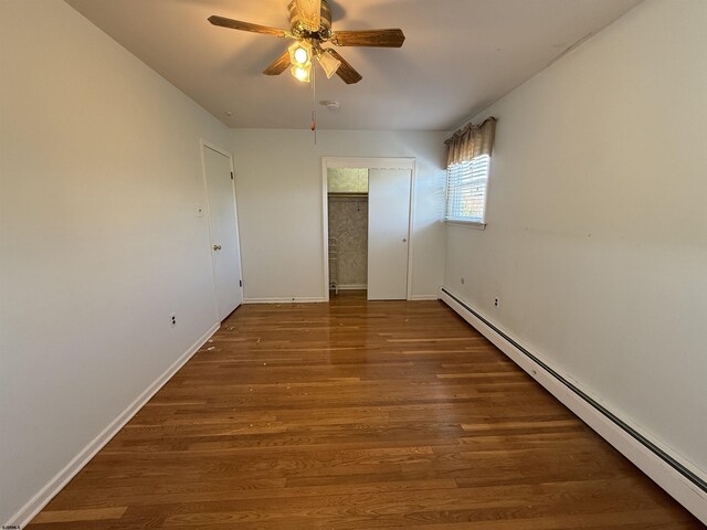 8508 Wellington Ave, Margate, NJ 08402 - unfurnished room featuring baseboard heating, wood finished floors, ceiling fan, and baseboards