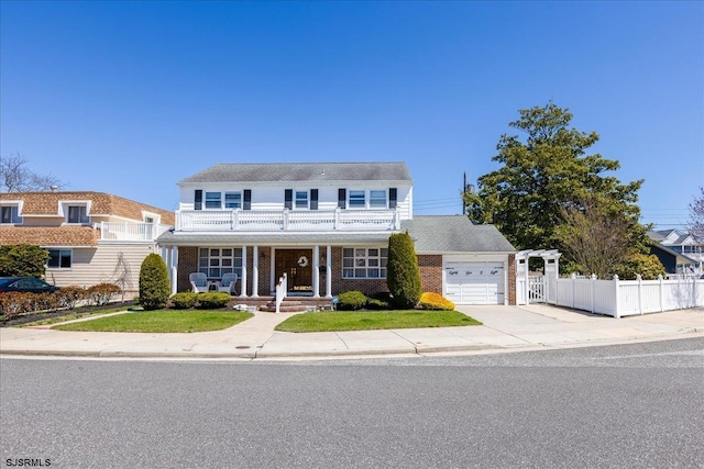 8508 Wellington Ave, Margate, NJ 08402 - traditional home with a balcony, a porch, an attached garage, concrete driveway, and brick siding