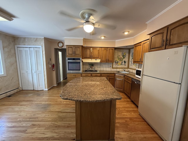 8508 Wellington Ave, Margate, NJ 08402 - kitchen featuring stainless steel appliances, a kitchen island, ceiling fan, under cabinet range hood, and ornamental molding