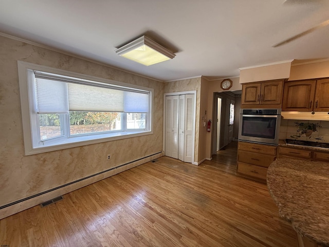 8508 Wellington Ave, Margate, NJ 08402 - kitchen featuring stainless steel oven, light wood finished floors, a baseboard heating unit, crown molding, and under cabinet range hood