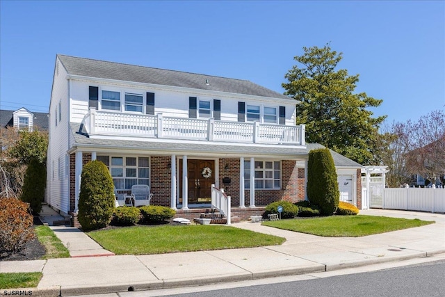 8508 Wellington Ave, Margate, NJ 08402 - traditional-style house with a balcony, a porch, a garage, brick siding, and concrete driveway