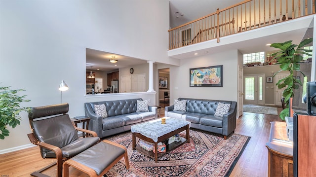 54 Hartford Dr, Egg Harbor Township, NJ 08234 - living room with decorative columns, a high ceiling, wood finished floors, and baseboards