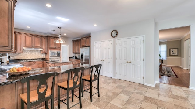 54 Hartford Dr, Egg Harbor Township, NJ 08234 - kitchen featuring stainless steel appliances, tasteful backsplash, dark stone counters, a kitchen breakfast bar, and recessed lighting