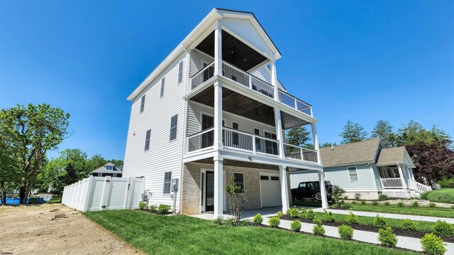 42 E New York Ave, Somers Point, NJ 08244 - view of front facade featuring a balcony, an attached garage, and brick siding