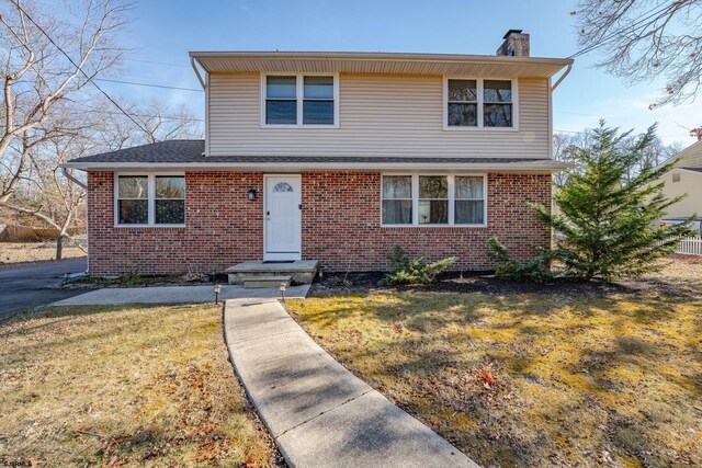 464 S Ash Ave, Galloway Township, NJ 08205 - view of front of property featuring a chimney, brick siding, a front lawn, and roof with shingles