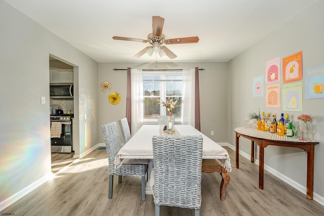 464 S Ash Ave, Galloway Township, NJ 08205 - dining space with light wood finished floors, a ceiling fan, and baseboards
