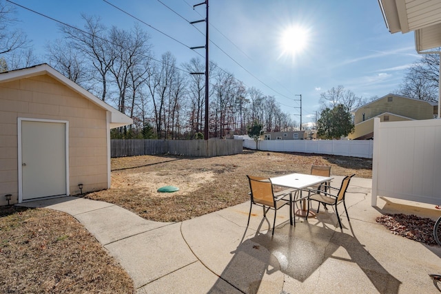 464 S Ash Ave, Galloway Township, NJ 08205 - view of patio featuring a fenced backyard, outdoor dining area, and an outbuilding