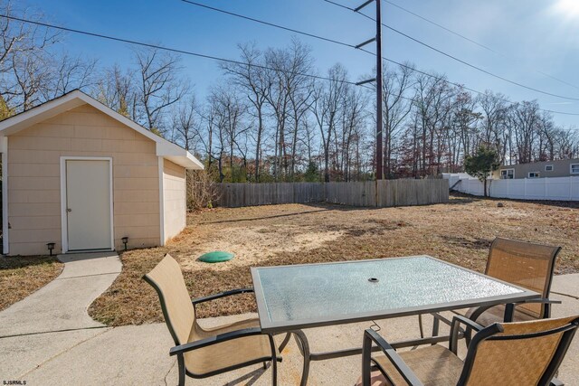 464 S Ash Ave, Galloway Township, NJ 08205 - view of patio / terrace with an outbuilding, fence, outdoor dining area, and a storage shed