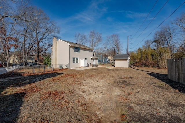 464 S Ash Ave, Galloway Township, NJ 08205 - back of property with fence, an outdoor structure, and a chimney