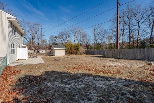464 S Ash Ave, Galloway Township, NJ 08205 - fenced backyard with an outdoor structure, a shed, and a patio