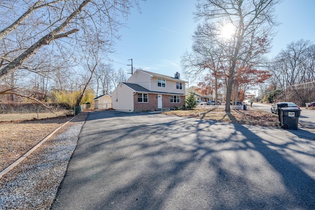 464 S Ash Ave, Galloway Township, NJ 08205 - rear view of property with asphalt driveway, a chimney, fence, and brick siding