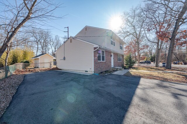 464 S Ash Ave, Galloway Township, NJ 08205 - view of home's exterior featuring fence, brick siding, and crawl space
