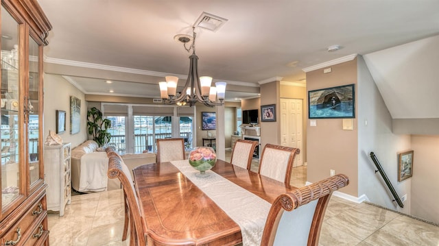 dining room with a chandelier, ornamental molding, light tile patterned floors, and baseboards