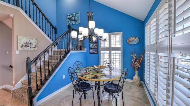dining room with high vaulted ceiling, stairs, a chandelier, and baseboards