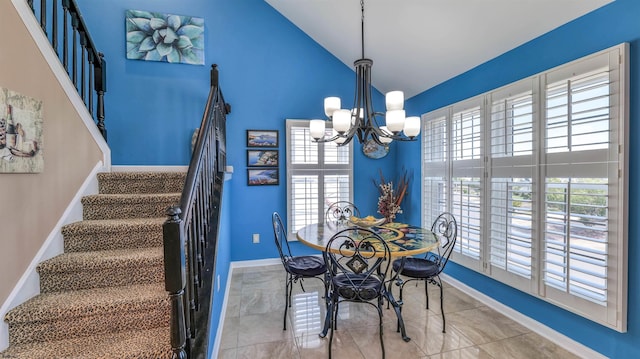 dining room featuring plenty of natural light, stairway, baseboards, and high vaulted ceiling