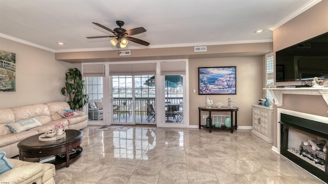 living room featuring crown molding, a fireplace, a ceiling fan, light marble finish flooring, and baseboards
