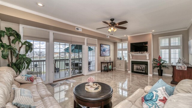 living area with ceiling fan, baseboards, a fireplace, crown molding, and recessed lighting